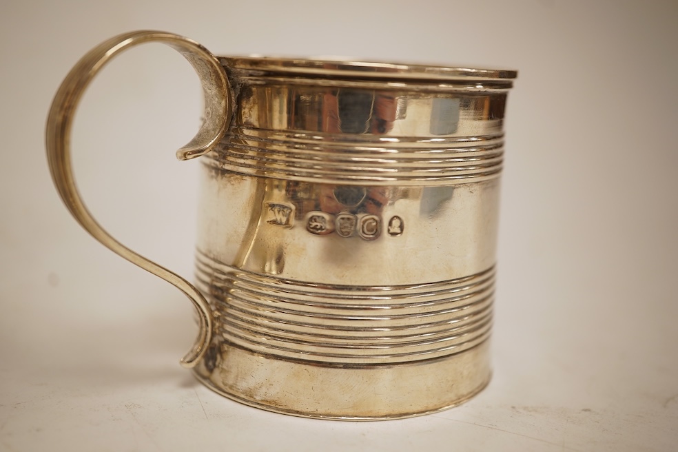 A small late George III reeded silver christening mug, London, 1818, height 51mm, together with a later Victorian silver christening mug, Arthur Sibley, London, 1764.